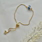 A floral bracelet in blue and white china pottery style with 1 beads laid down flat to show adjustable slider on the bracelet