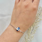 A floral bracelet with rhodium plated chain in blue and white china pottery style with 1 bead on a hand