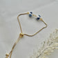 A floral bracelet in blue and white china pottery style with 2 beads laid down flat to show adjustable slider on the bracelet