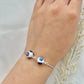A floral bracelet with rhodium plated chain in blue and white china pottery style with 2 beads on a hand