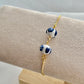 A floral bracelet in blue and white china pottery style with 2 beads on a bracelet holder