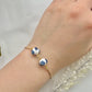 A floral bracelet in blue and white china pottery style with 2 beads on a hand
