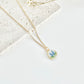 Gold clay necklace with a pendant featuring a floral design on a light background