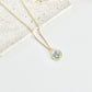 Gold clay necklace with a floral pendant on a light background