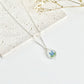 Silver clay necklace with a pendant featuring a floral design on a light background