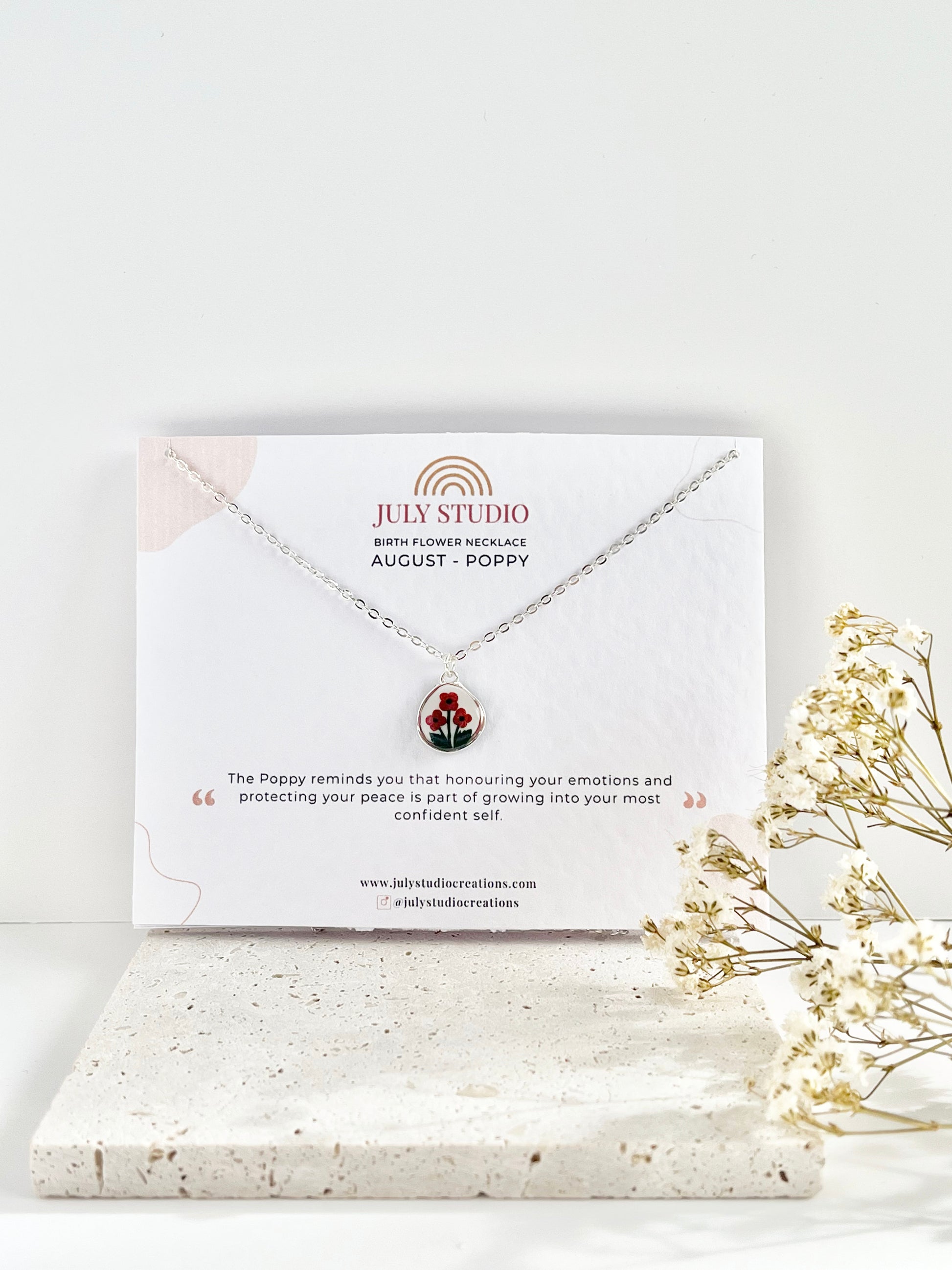 Silver clay necklace on a July Studio jewellery card card with a white background and dried flowers.